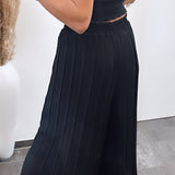 Maya | Pantaloni plisati Melnas — confort ușor și croială elegantă